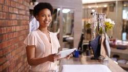 black business owner facing camera smiling